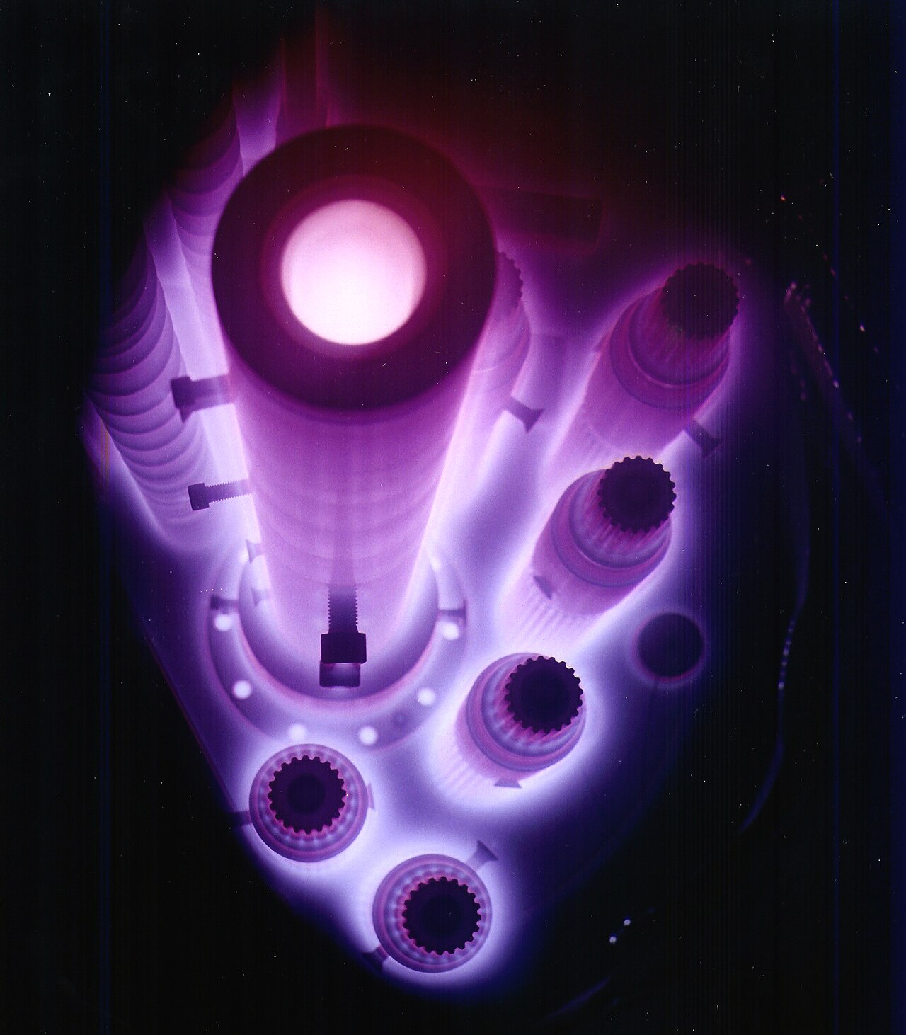 Components surrounded by the glow of pulse plasma nitriding